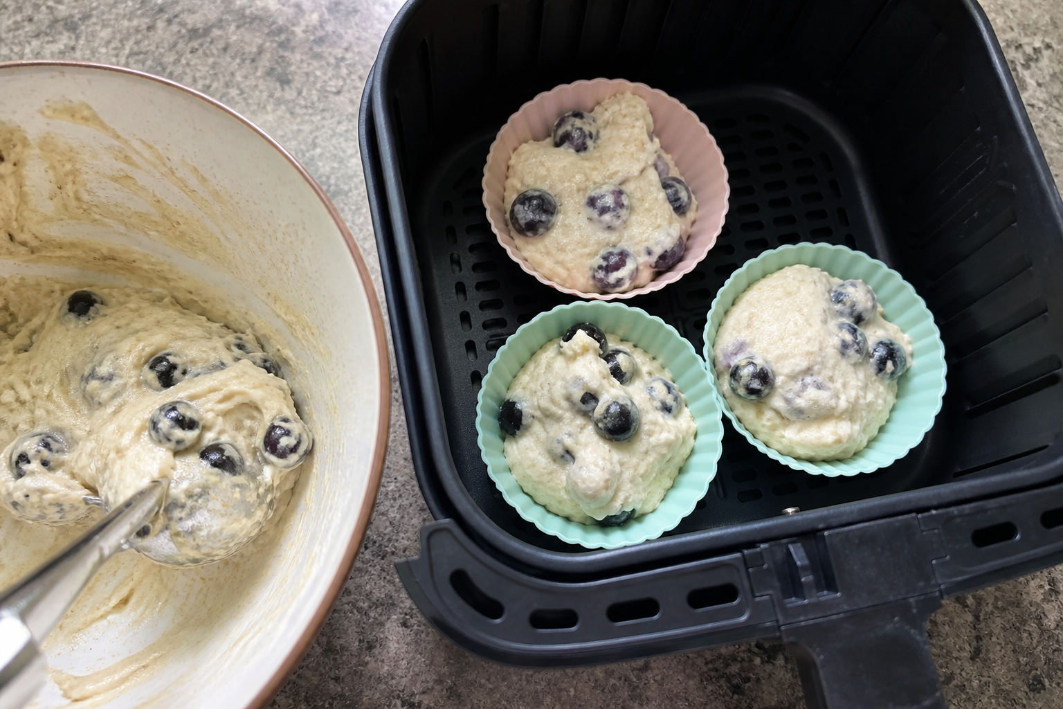 Blueberry muffin batter portioned into stable silicone cups for an air fryer