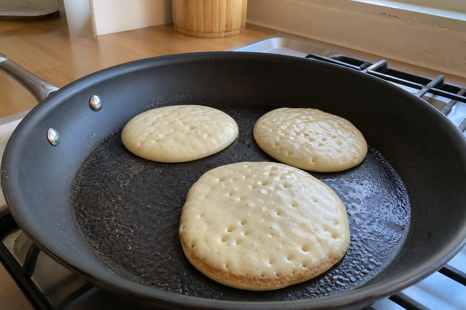 American pancakes cooking flat in a home skillet