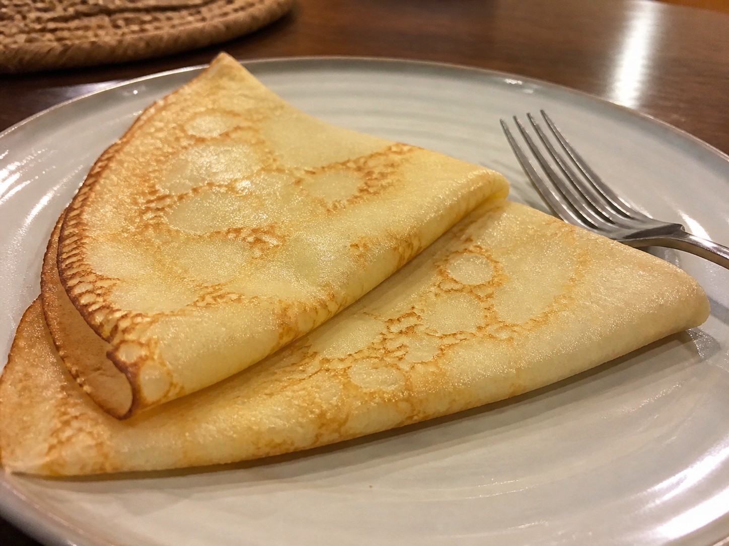 Soft thin folded crepes on a ceramic plate