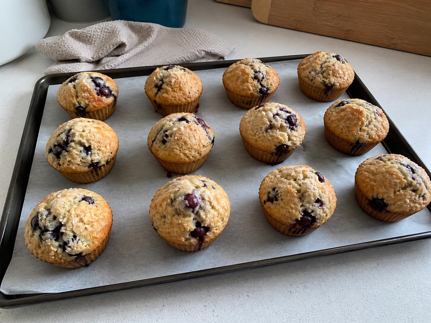 Cooled homemade muffins on a tray before freezing