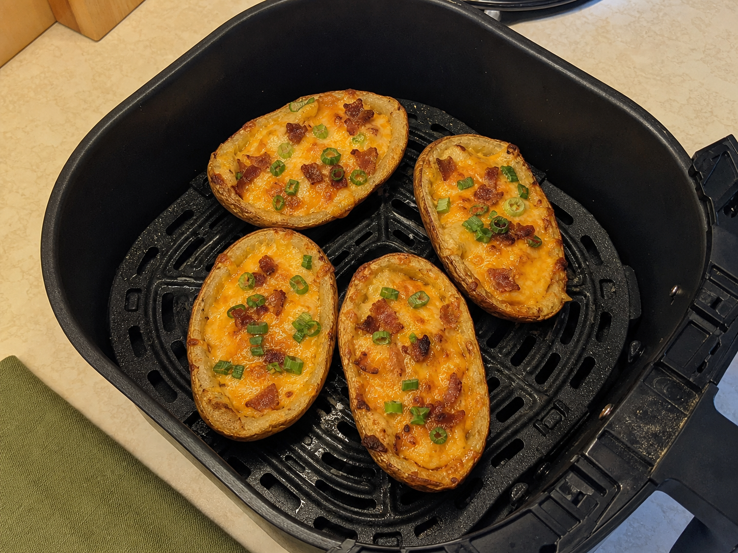 Top-down view of generic loaded potato skins arranged upright in an air fryer basket