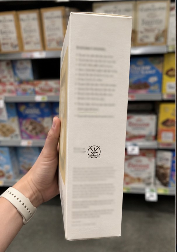 A simple bowl of golden cereal with milk on a wooden breakfast table
