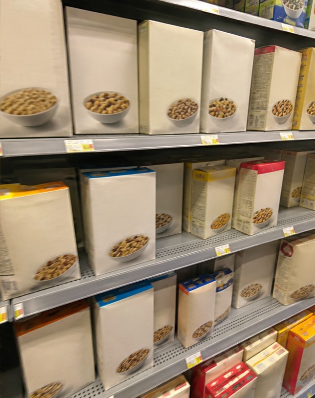A homemade cereal snack mix with dried fruit and seeds on a parchment-lined tray