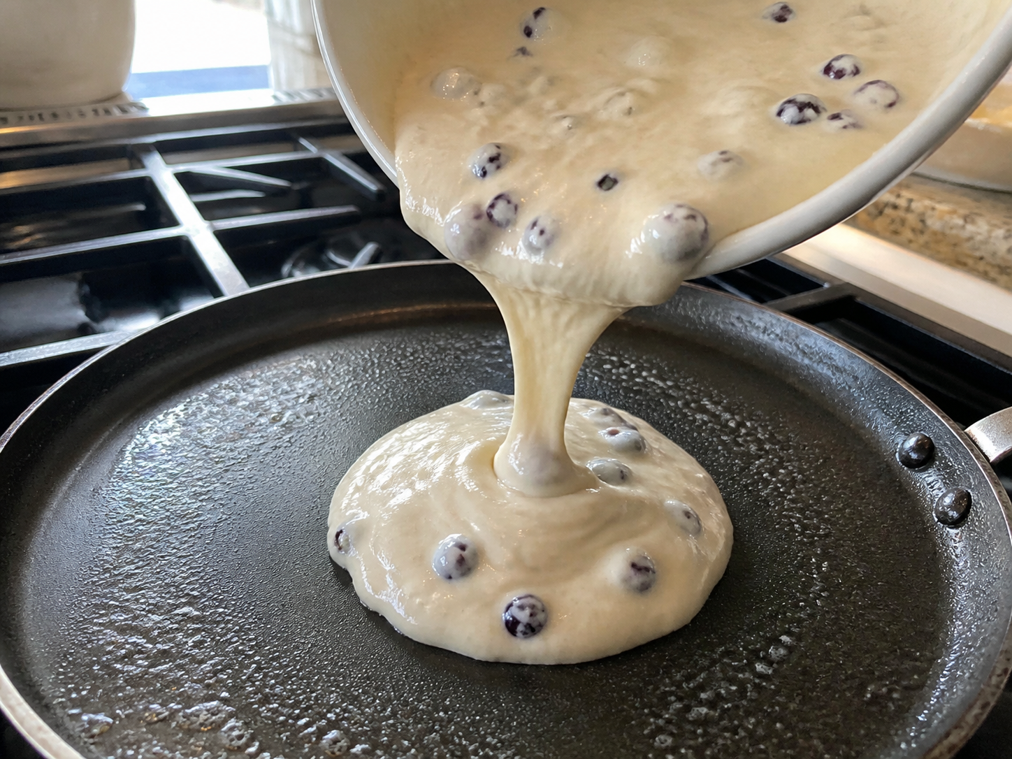 Muffin mix pancake batter poured onto a skillet