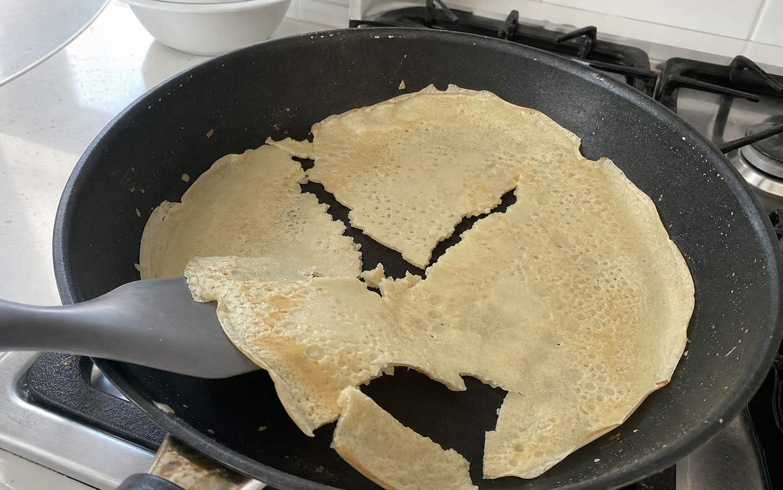 Pancakes, flour and a pan in a home kitchen