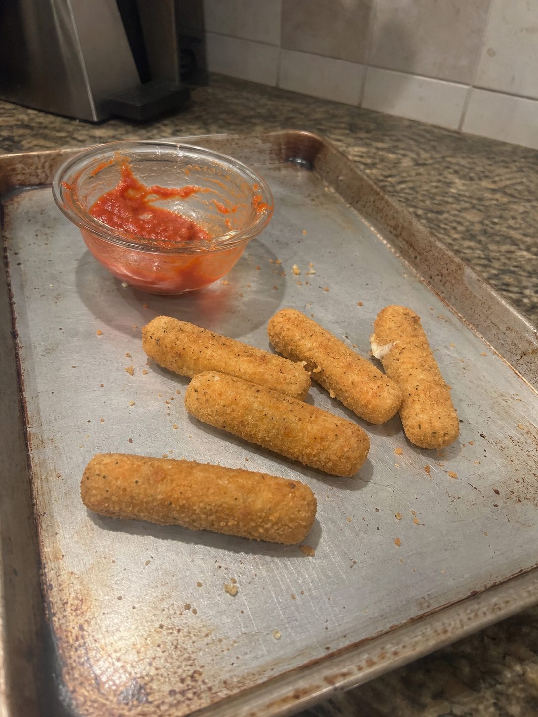 Breaded mozzarella sticks with marinara on the side