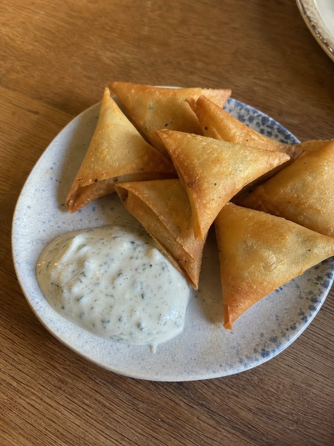 Golden mini samosas with mint yogurt dip