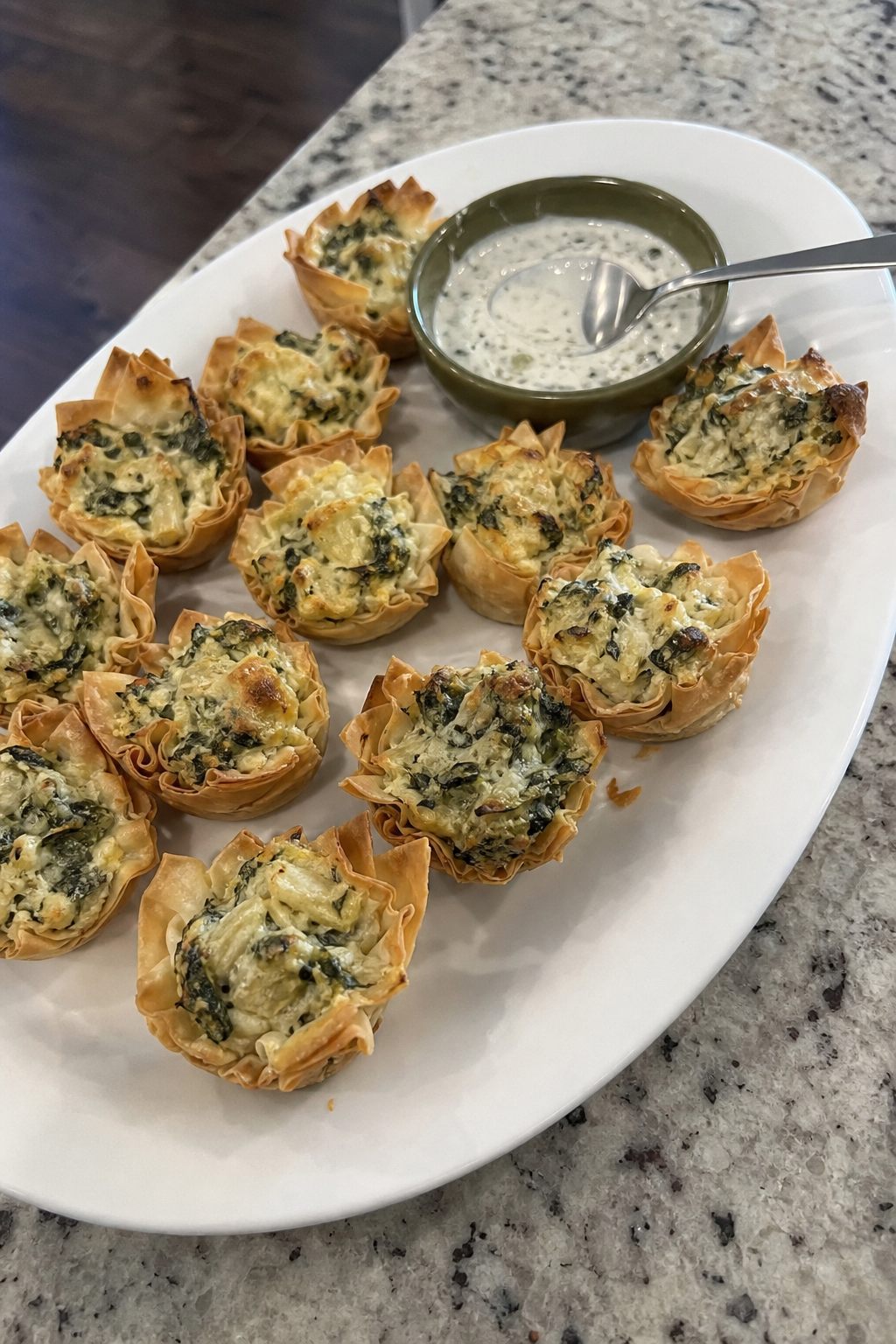 Spinach artichoke pastry bites with a cool dipping sauce