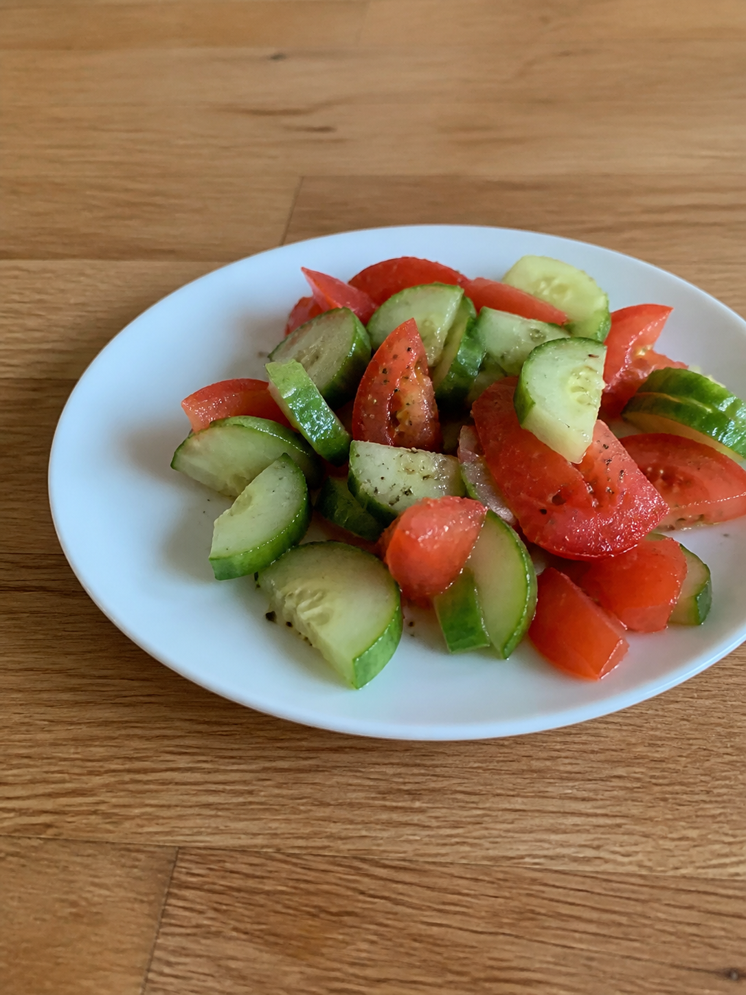 Cucumber and tomato salad on a small plate