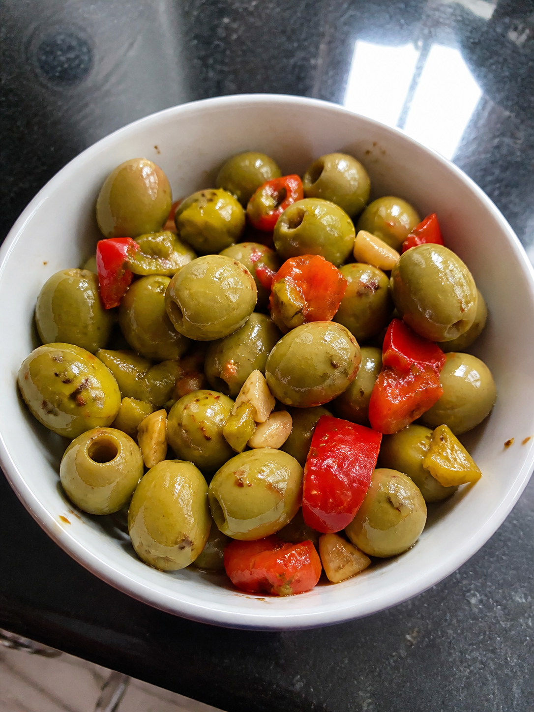 Olives and peppers in a bowl for a pizza party