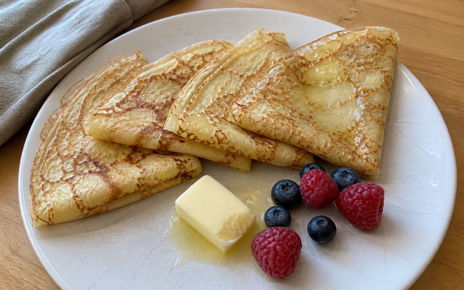 Freshly made folded crepes on a home kitchen table, ready to be gently reheated