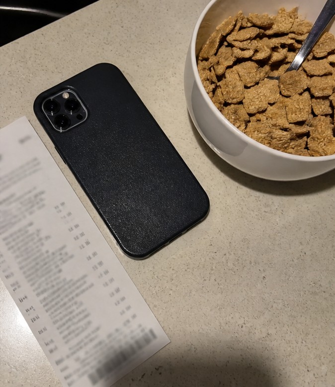 A homemade cereal snack mix with dried fruit and seeds on a parchment-lined tray