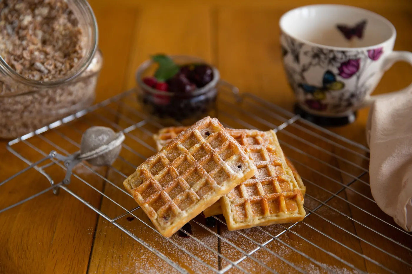 Golden waffles cooling on a rack